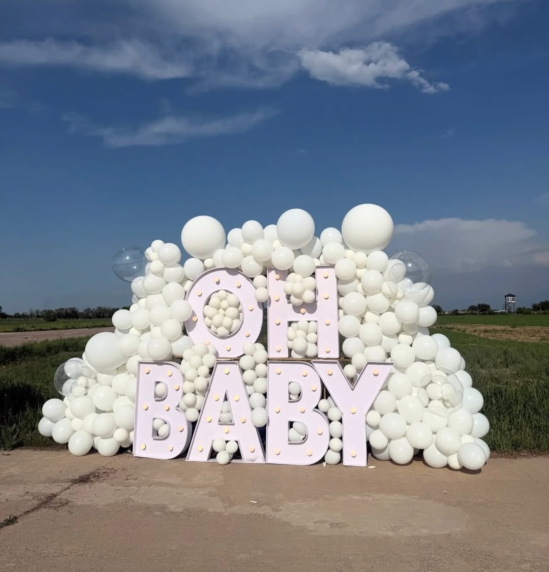 Party Land gender reveal: All-white OH BABY setup